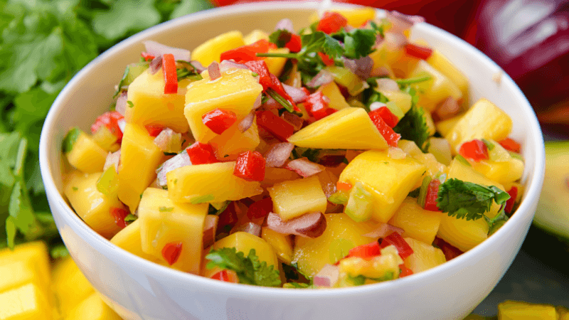 delicious and chunky mango salsa served in a white bowl