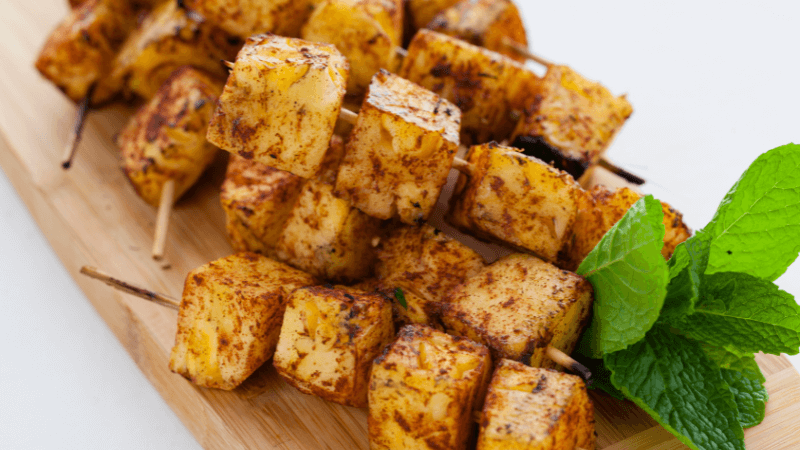 grilled pineapple skewers with mint leaves