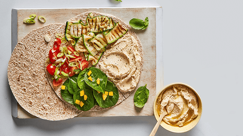 delicious Mediterranean Antipasti Grilled Veggie Wrap made with tortillas served on wooden board